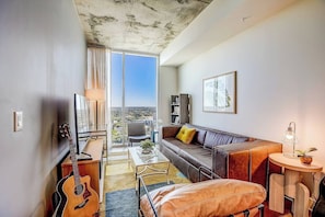 Comfy leather enhanced living room with a view toward the East