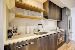 Full kitchen with convection oven, stove tops, dishwasher, and refrigerator