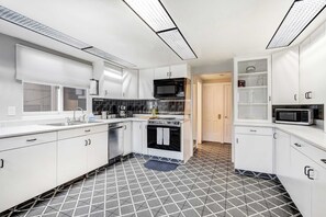 Whip up meals with ease in the spacious full kitchen, featuring stainless steel appliances, plenty of counter space, and all the essentials for your stay.

