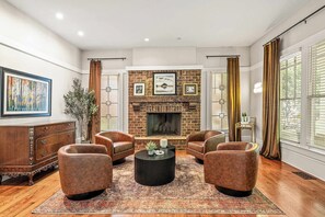Where cozy elegance meets timeless comfort — leather seats, a warm fireplace, and a perfectly stocked bar cart await your next gathering.