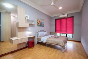 The master bedroom with a queen-sized bed and an en-suite bathroom.