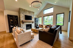 Kick back and relax in the living room, taking advantage of the inviting seating, a large smart TV, and a cozy gas fireplace.