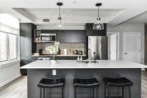 Fully equipped kitchen with a breakfast counter (seats 3) and a dining area (seats 4), plus a high chair available for little ones.