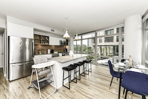 Fully equipped kitchen with a breakfast counter (seats 3) and a dining area (seats 4), plus a high chair available for little ones.