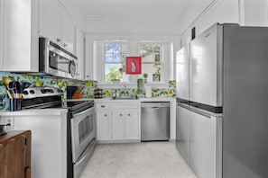 "Fully equipped kitchen with modern appliances and plenty of space to cook, gather, and enjoy meals together."