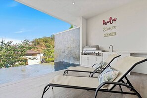 The covered terrace is a great spot for relaxing by the pool.  