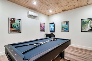 Challenge friends to a spirited game on the sleek pool table amidst stylish decor!