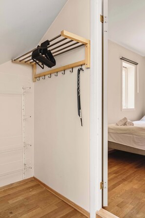 Practical entryway with wall-mounted hooks and hangers to keep your coats and bags neatly organized.