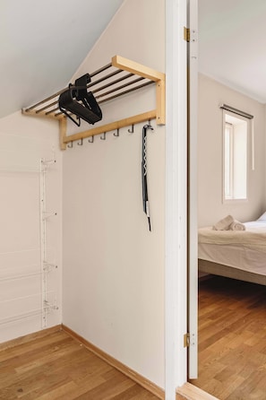 Practical entryway with wall-mounted hooks and hangers to keep your coats and bags neatly organized.