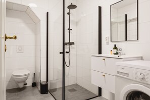 A stylish bathroom featuring a glass-enclosed shower, clean tiles, and modern fixtures for a refreshing start to your day.