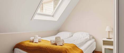 A bright sleeping nook featuring a comfy bed and a soft, warm blanket for added comfort.