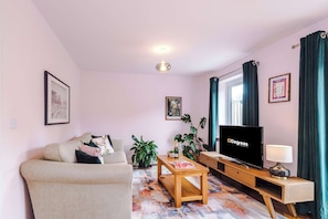 The light and cozy living room makes the perfect place for you to relax in the evening and enjoy the use of the SMART TV.