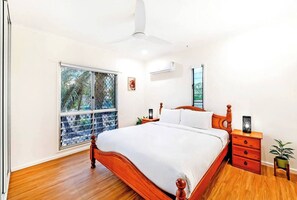 The spacious primary bedroom features a king-size bed, built-in robes, an ensuite and cooling to keep things comfortable.
