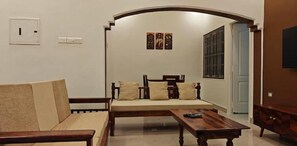 Living room seating view and dining behind the arch