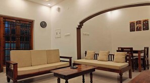 Living room seating and dining behind the arch