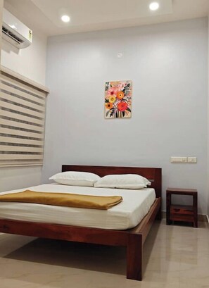 A/C bedroom with attached bathroom, wardrobe and remote operated ceiling fan