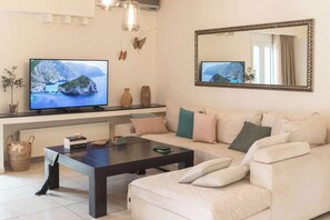 Bright Living Area with Garden View
Flooded with natural light through large windows, this airy space invites relaxation and socializing.