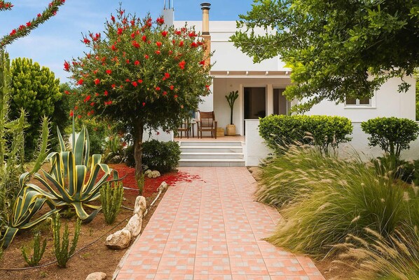 Lush Garden with Mediterranean Flora
The front garden is landscaped with vibrant, local plants that enhance privacy and provide a relaxing atmosphere.