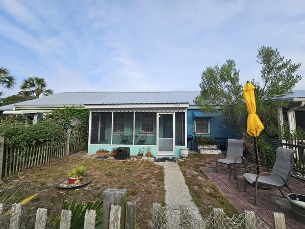 Fenced-in front yard with screened-in porch