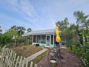 Fenced-in front yard with outdoor seating for two