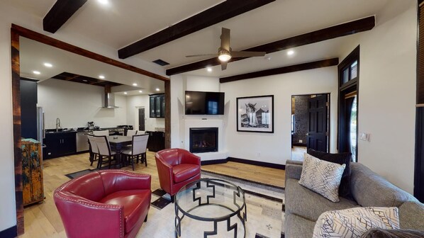 Open living room with full seating and gas fire place