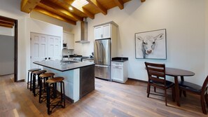 Kitchen and living space is filled with natural light