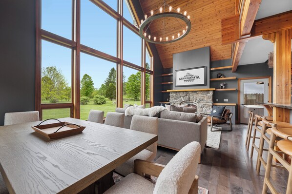 Luxurious great room with stone fireplace and sweeping views of Mount Mansfield