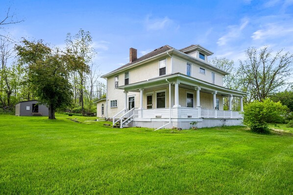 Spacious corner lot with lush greenery and timeless curb appeal—ideal for outdoor entertaining and peaceful retreats.