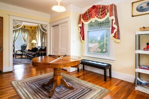 Charming game room with vintage details, a convertible game table, and large windows overlooking lush greenery 🌳🎯📚