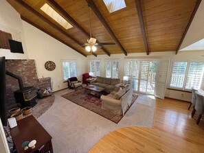 Living room with high wood beam ceilings.