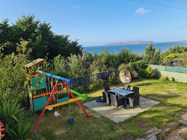 Garden with sea view.  Comfy Garden chairs and egg chair. For kids swing and slide ofcourse 😉 