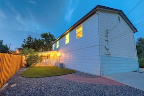 Enjoy the fenced backyard space to the left—please note that the area beyond the white fence belongs to the downstairs unit.