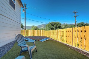 Step into the shared backyard and enjoy mountain views, cornhole, and a quiet spot to relax in the fresh Colorado air

