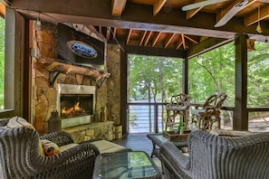 Whisperbend Offers An Outdoor Fireplace With TV Overlooking The River