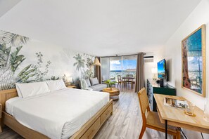 Beautiful studio with queen-size bed perfect for relaxing, designated working space with table and chair, futon sofa, window AC, and a 54" Smart TV.