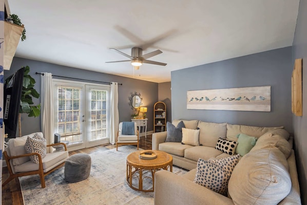 Relax in Style: Cozy Living Room with Plush Seating, Warm Lighting, and Space for the Whole Family!