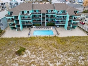 Pool open seasonally. Condo is 1st floor, above parking, on the left.
