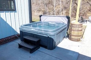 Relax & Unwind – This private hot tub is perfect for a soothing soak under the stars, with a cozy fire pit and ambient string lights enhancing the outdoor retreat.