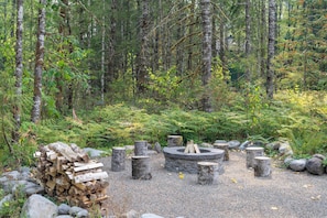 Gather 'round the cozy fire pit under the trees! Perfect for sharing stories and making memories.