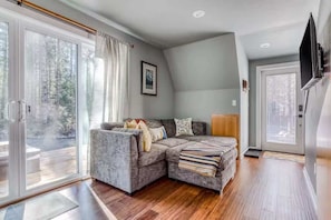 Kick back and relax in this cozy living space with easy access to the outdoors. Perfect for unwinding after a day of adventure!