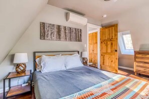 Relax in this bright, cozy bedroom with unique artwork and a comfy bed. Your perfect rest stop!