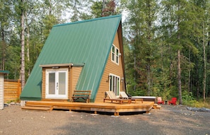 Your cozy A-frame escape awaits! Relax on the deck or soak in the hot tub surrounded by nature. Book your unique getaway now!