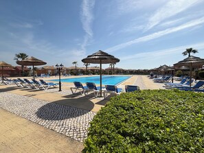 Large pool with plenty of sunloungers and  umbrellas