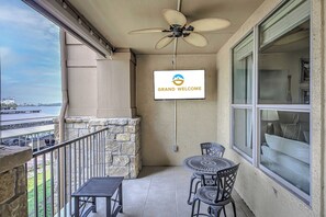 Spacious balcony with outdoor seating and TV