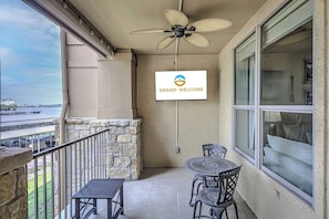 Spacious balcony with outdoor seating and TV