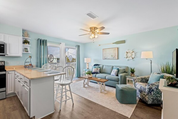 Living room with sleeper sofa, opens to private wrap around balcony