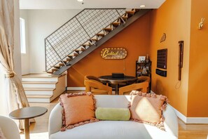 Living Room: Welcome to our haven of warmth and joy! Dive into the heart of relaxation in our cozy living room, where every corner invites laughter and cherished moments with loved ones.