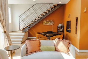 Living Room: Welcome to our haven of warmth and joy! Dive into the heart of relaxation in our cozy living room, where every corner invites laughter and cherished moments with loved ones.