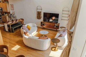 Living Room: Welcome to our haven of warmth and joy! Dive into the heart of relaxation in our cozy living room, where every corner invites laughter and cherished moments with loved ones.