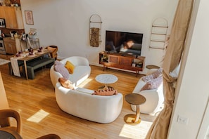 Living Room: Welcome to our haven of warmth and joy! Dive into the heart of relaxation in our cozy living room, where every corner invites laughter and cherished moments with loved ones.